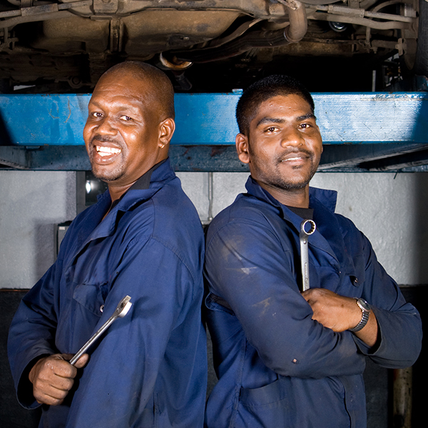 Two student standing in front of car