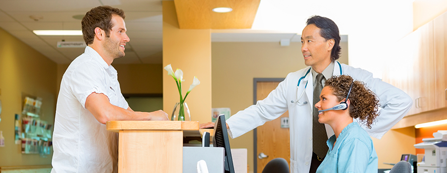 Assistant working in front desk with doctor