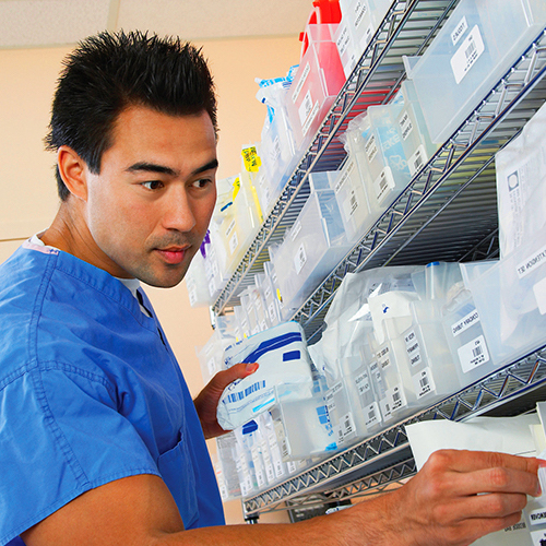 Student putting medication on shelf