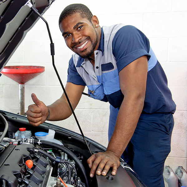 Mechanic working on car in shop